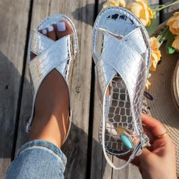 A pair of flat sandals with a round toe and a stylish open-toe design, perfect for summer. They are lightweight and durable, mak